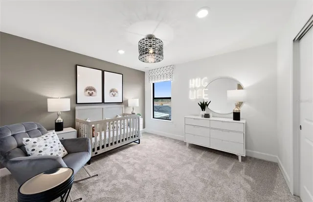 a bedroom with a large bed and a chandelier