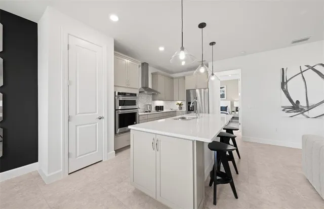 a view of a kitchen with refrigerator and cabinets