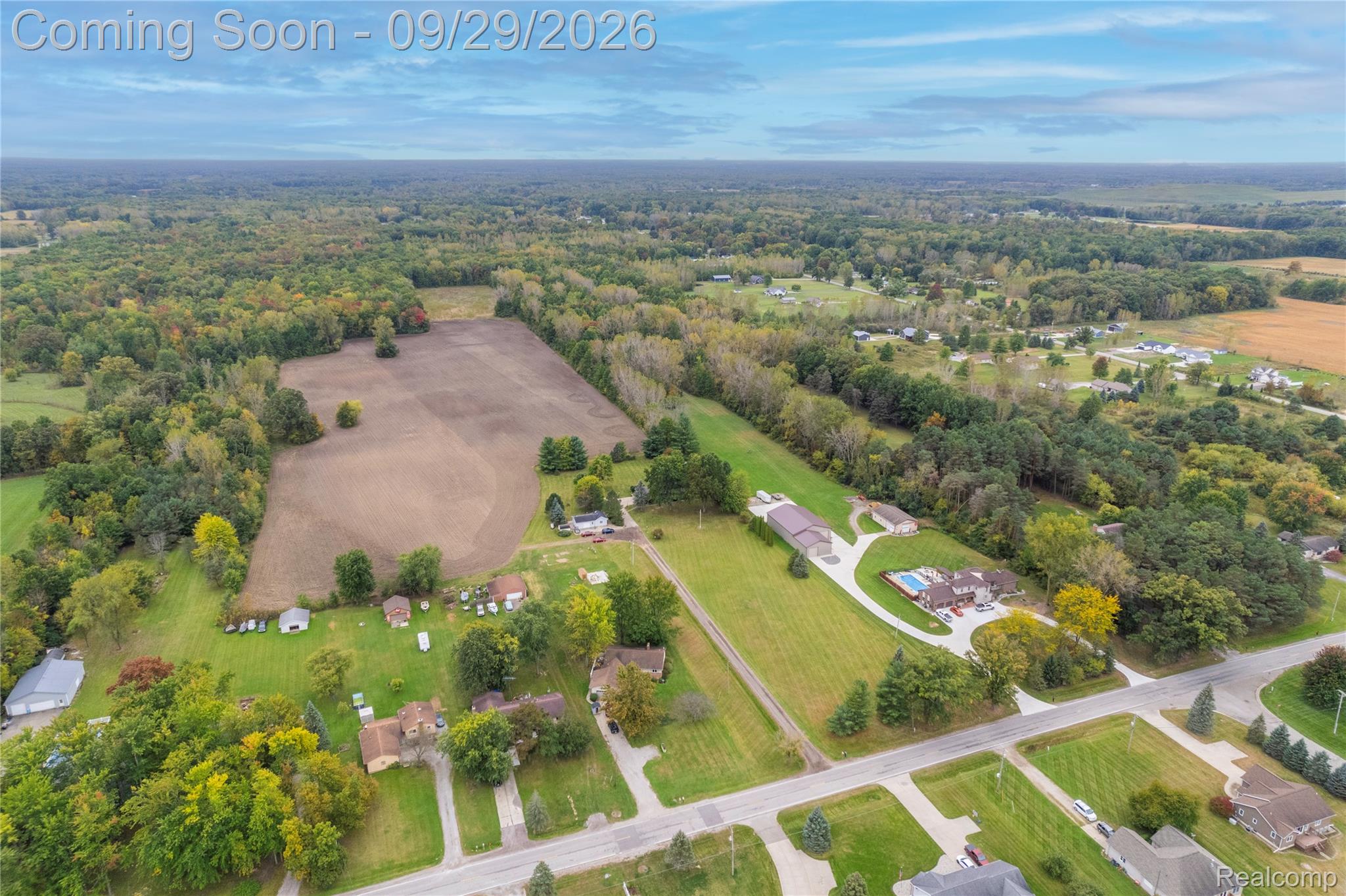 6411 Farrand Road Clio, MI 48420 - Photo 4 of 33 Expansive property featuring a cultivated field, mature trees, and a beautiful home.
