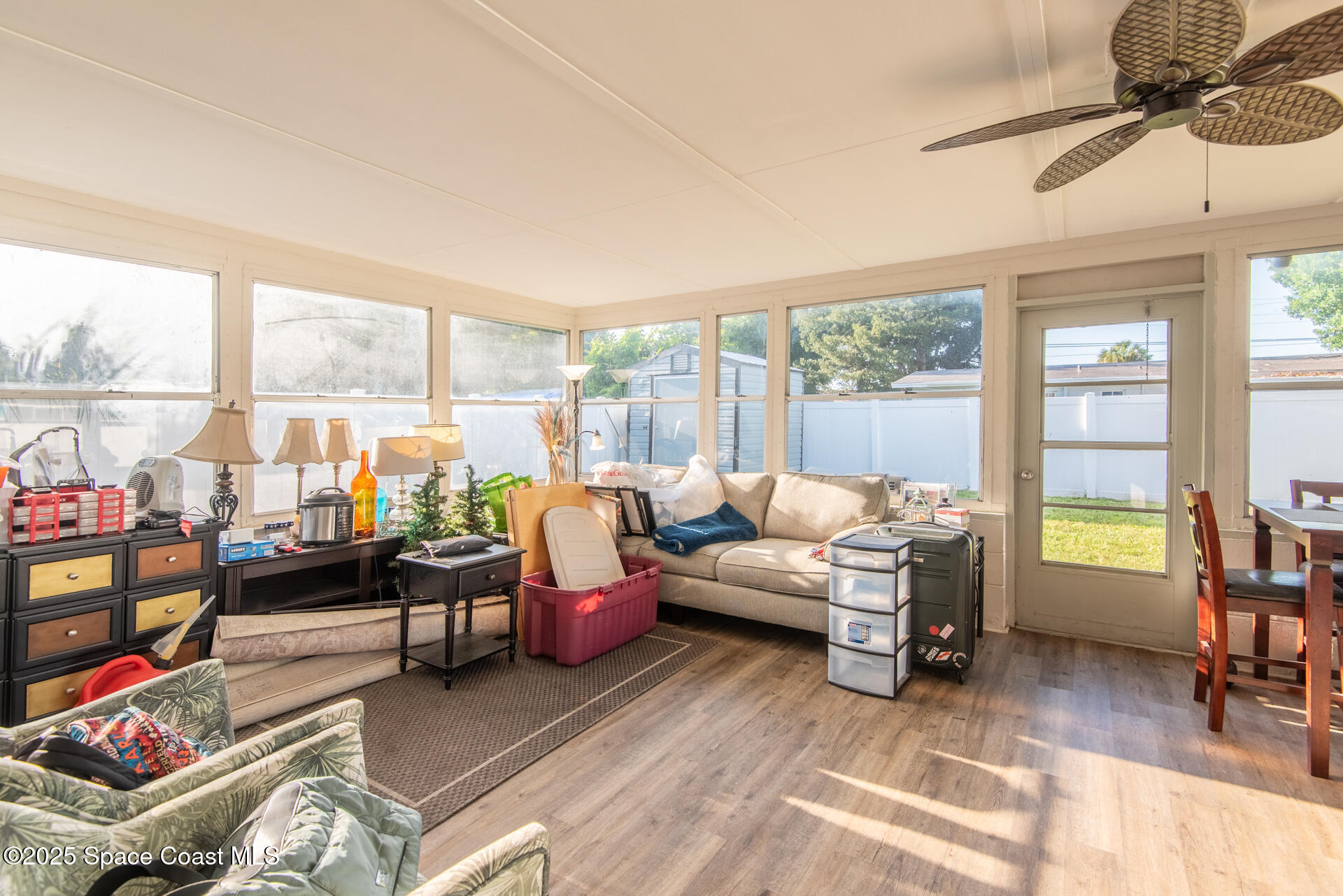 2910 Tropic Road Melbourne, FL 32935 - Photo 14 of 18 a living room with furniture and floor to ceiling windows