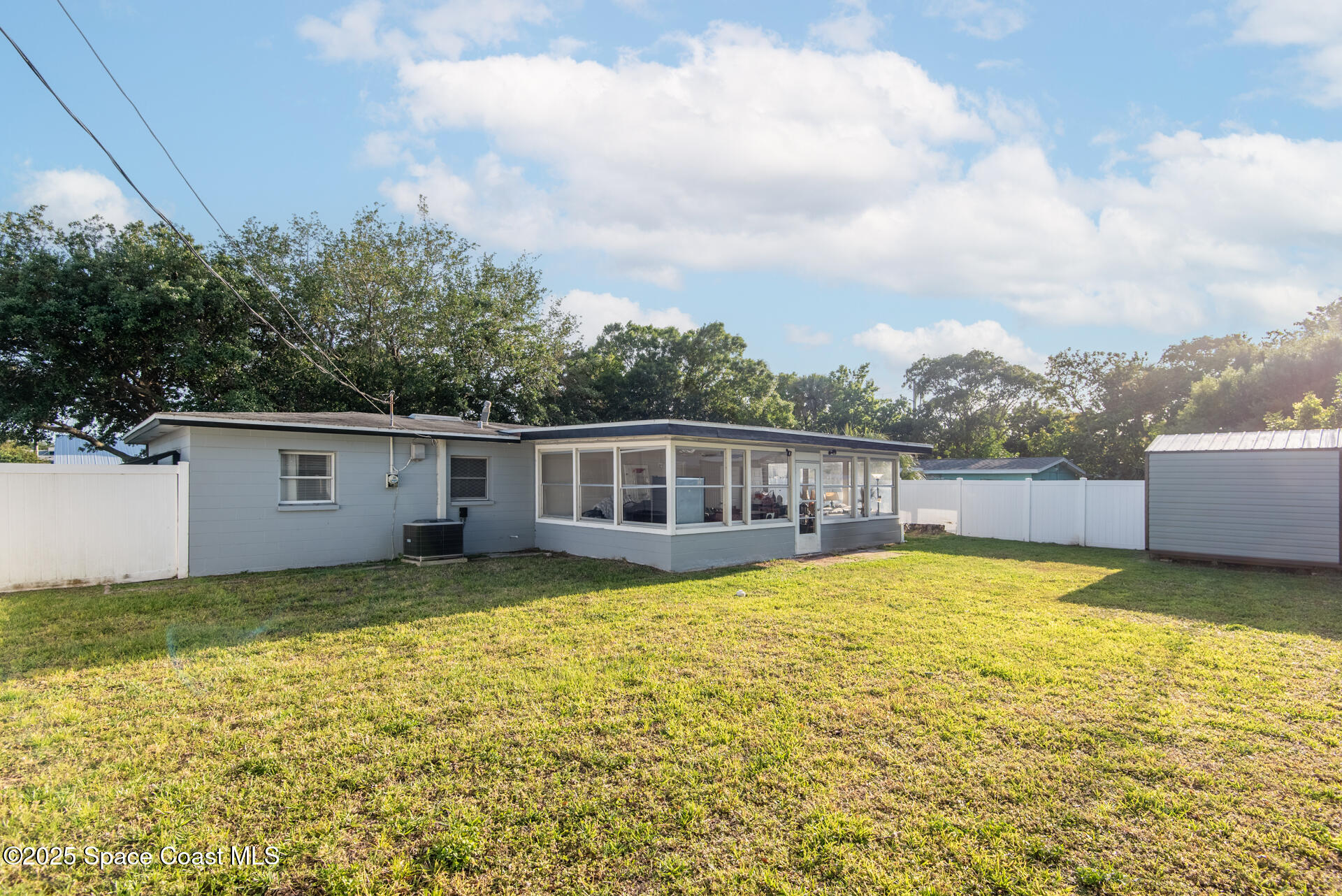 2910 Tropic Road Melbourne, FL 32935 - Photo 17 of 18 a view of a house with pool and yard