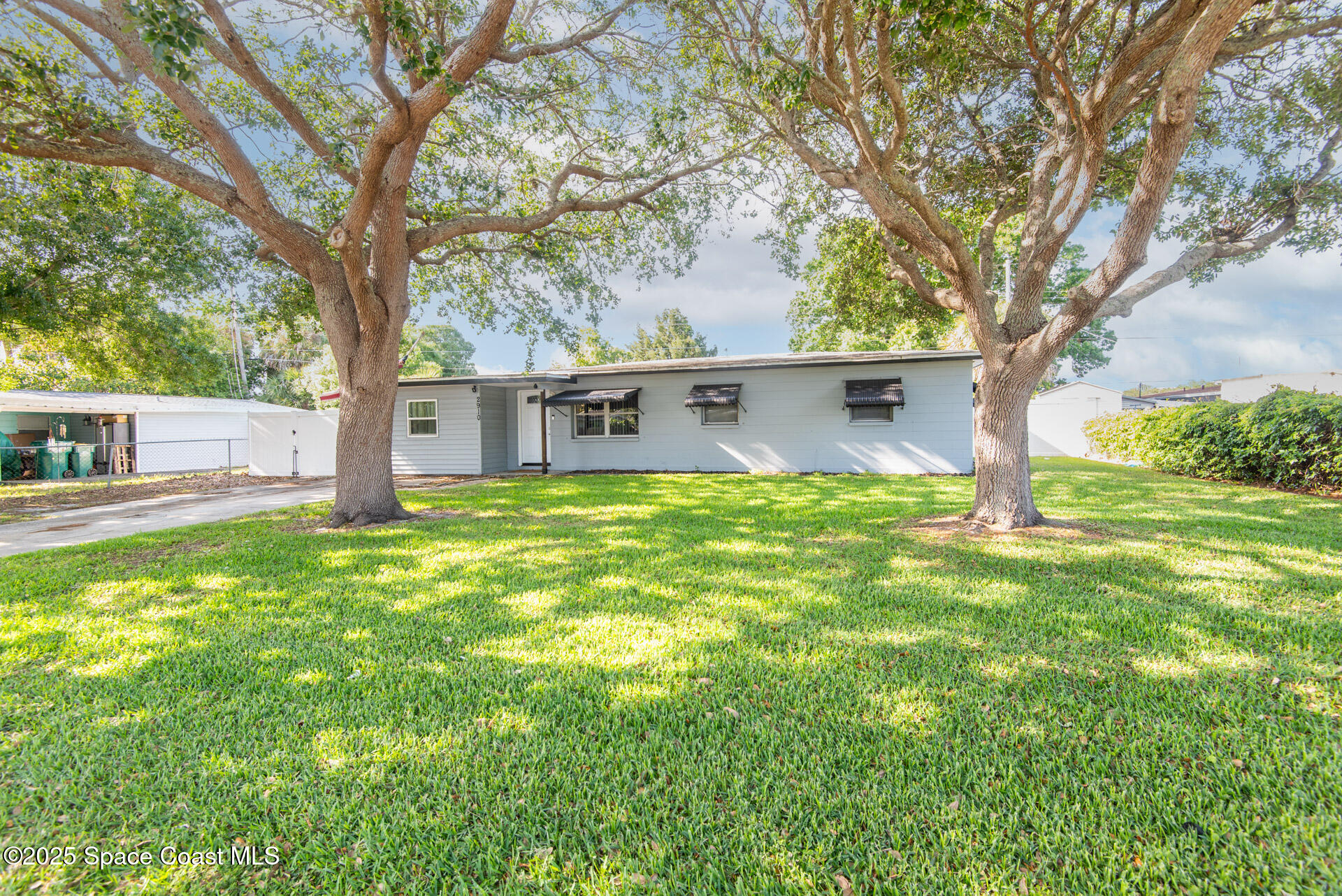 2910 Tropic Road Melbourne, FL 32935 - Photo 3 of 18 a view of house with backyard and trees