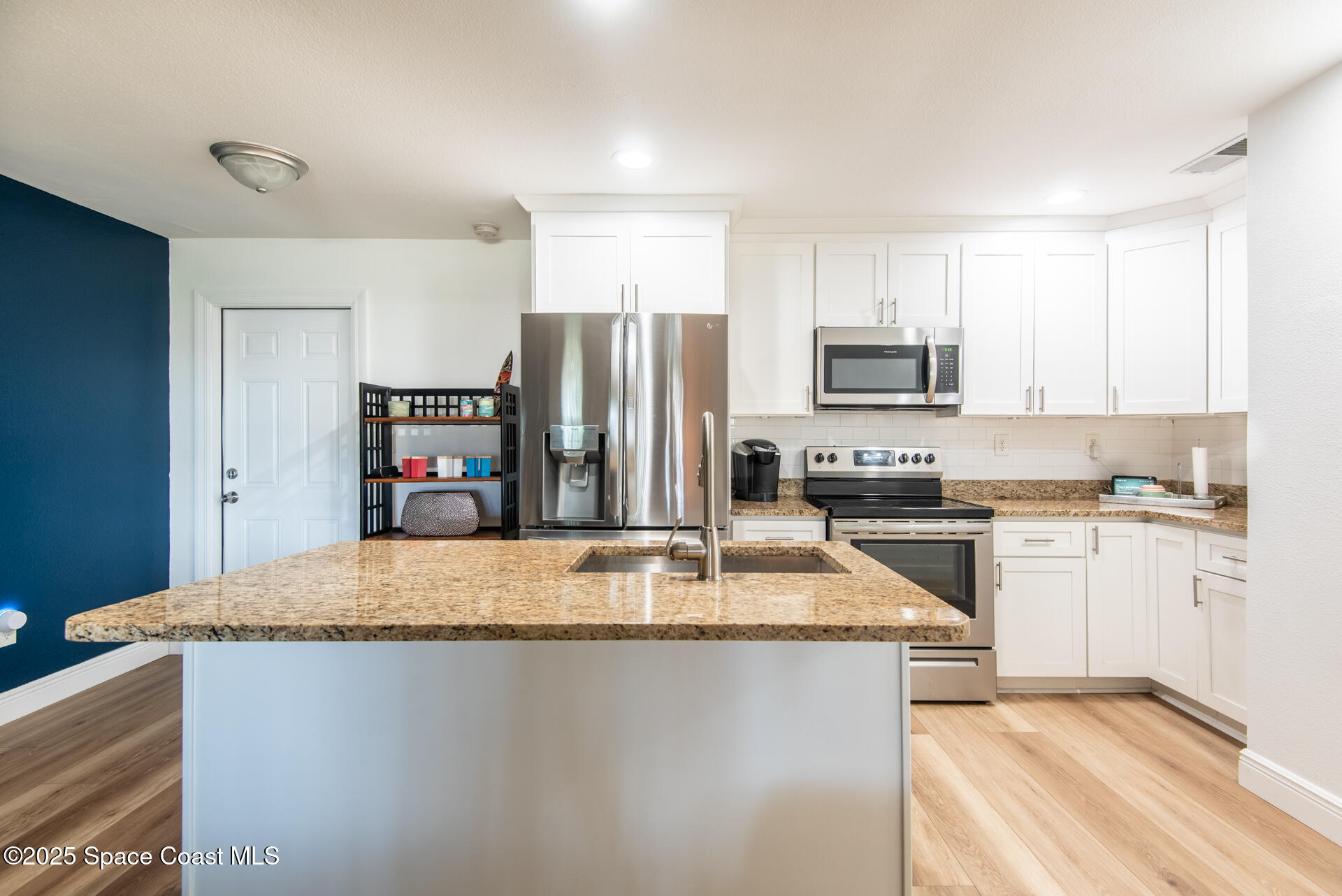2910 Tropic Road Melbourne, FL 32935 - Photo 5 of 18 a kitchen with kitchen island a counter top space cabinets and stainless steel appliances