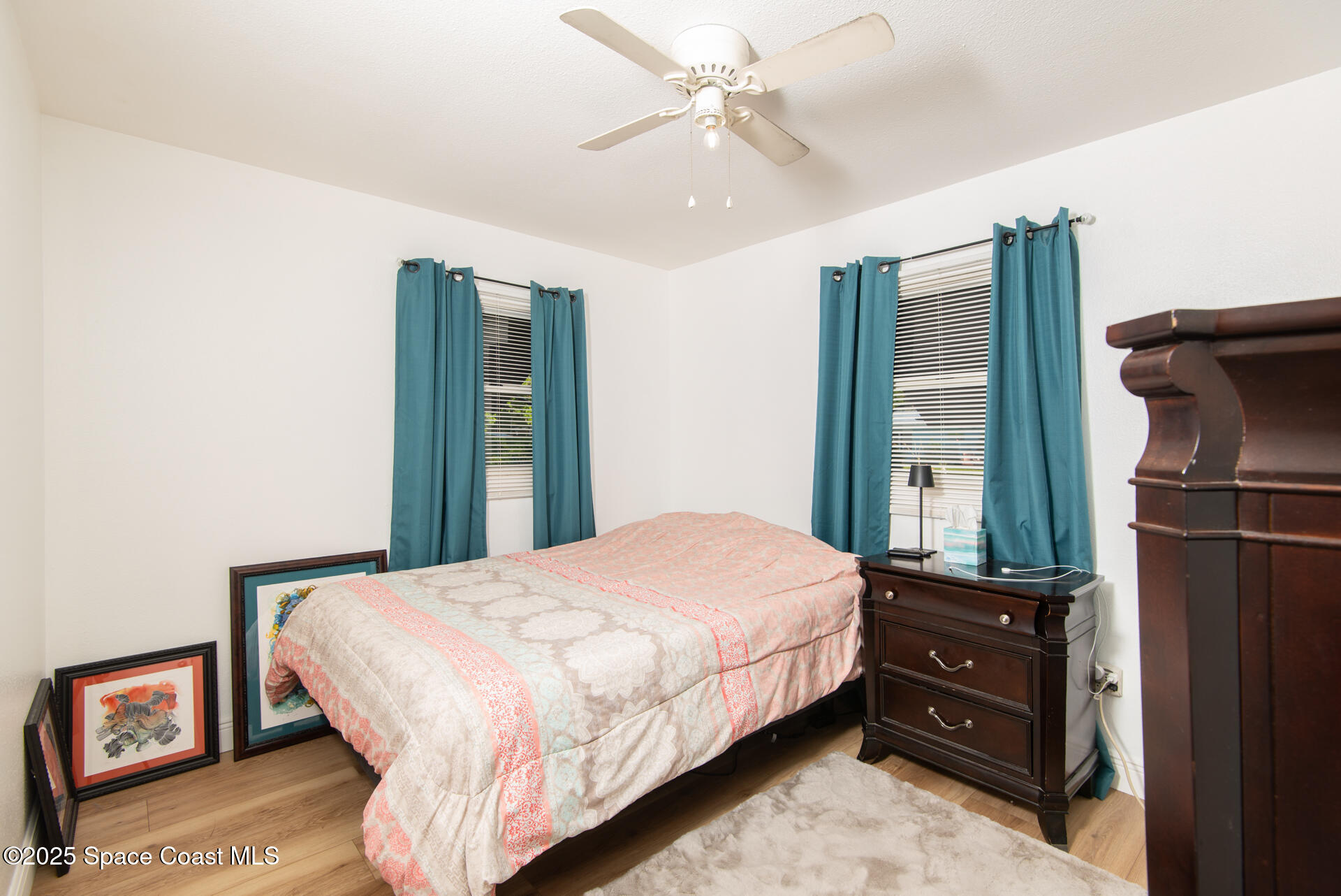 2910 Tropic Road Melbourne, FL 32935 - Photo 7 of 18 a bedroom with a bed and a mirror