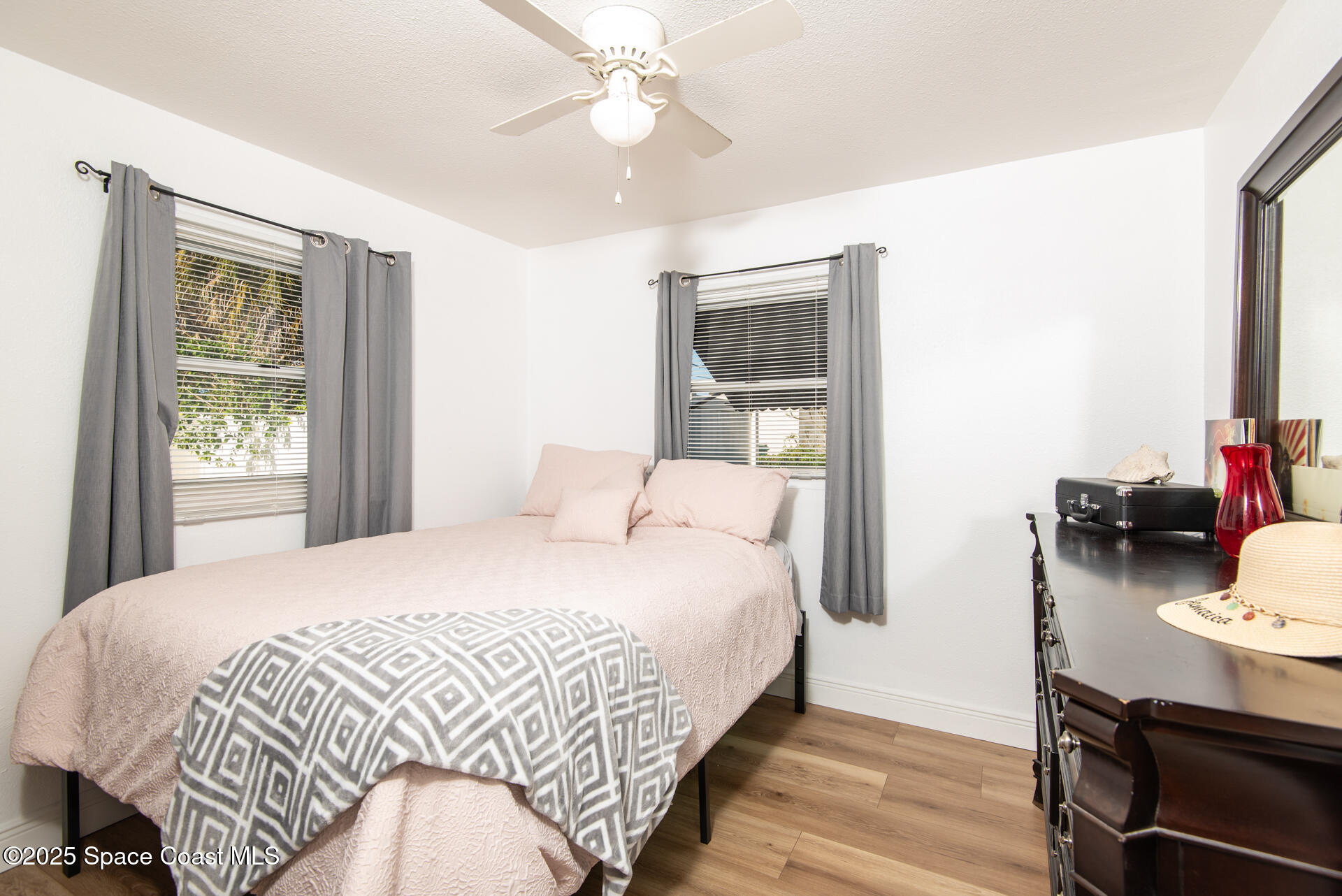 2910 Tropic Road Melbourne, FL 32935 - Photo 8 of 18 a bedroom with a bed and wooden floor