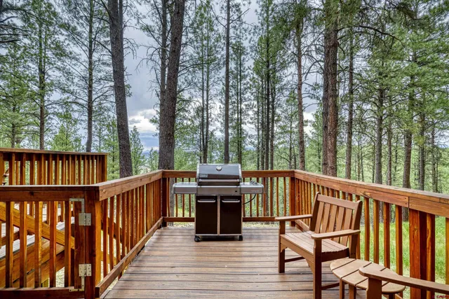 a view of a balcony with chairs and wooden floor