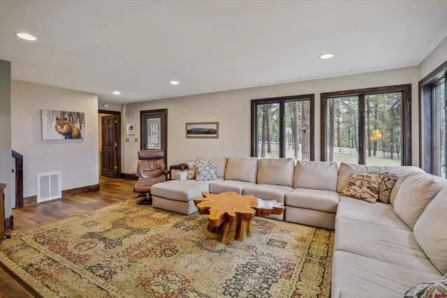 a living room with furniture windows and a flat screen tv