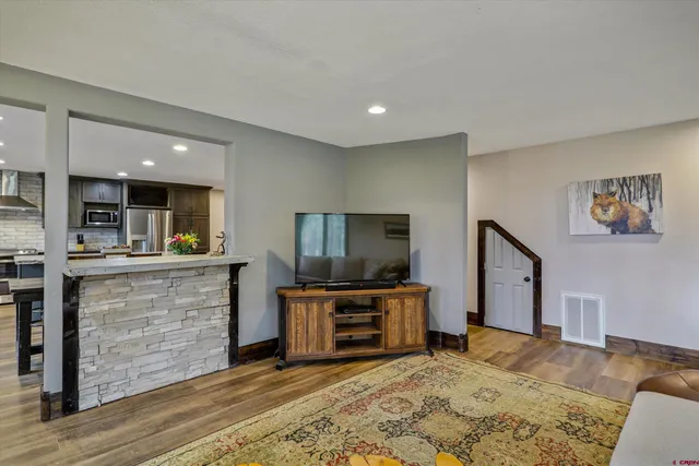 a living room with furniture and a flat screen tv
