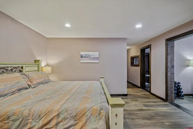 a room with a bed and a dresser