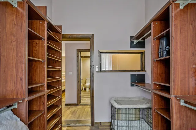 a view of bedroom with a large window and wooden floor