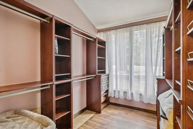 a bedroom with a bed and a large mirror