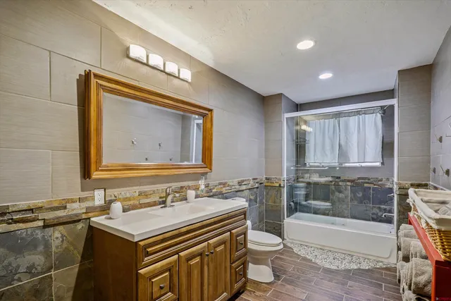 a living room with furniture and a book shelf