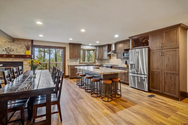 a kitchen with kitchen island granite countertop a stove and a sink