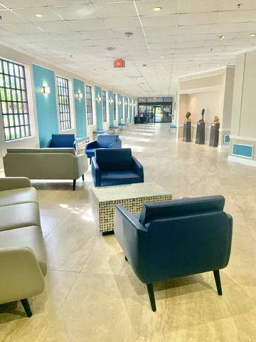 a living room with furniture and a pool table