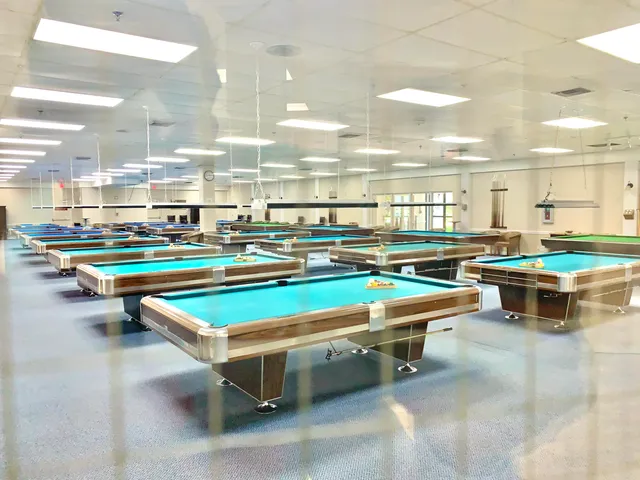 a outdoor space with pool table and chairs