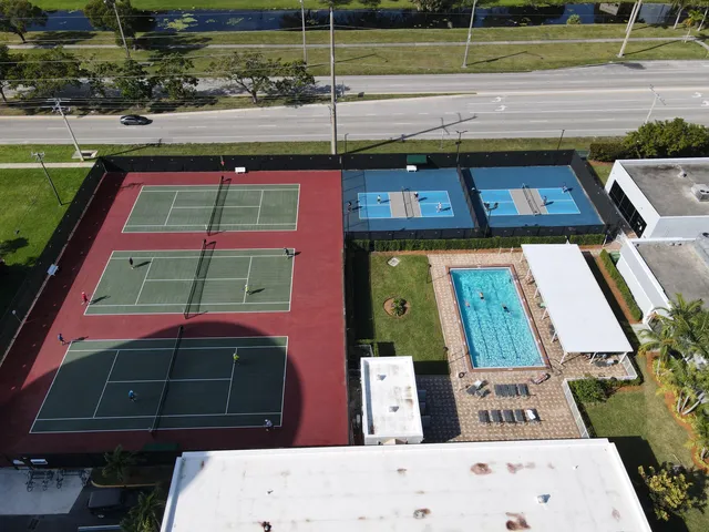 a view of a tennis court with a bench in it