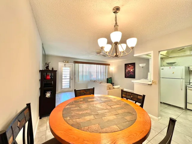 a view of a dining room with furniture and chandelier