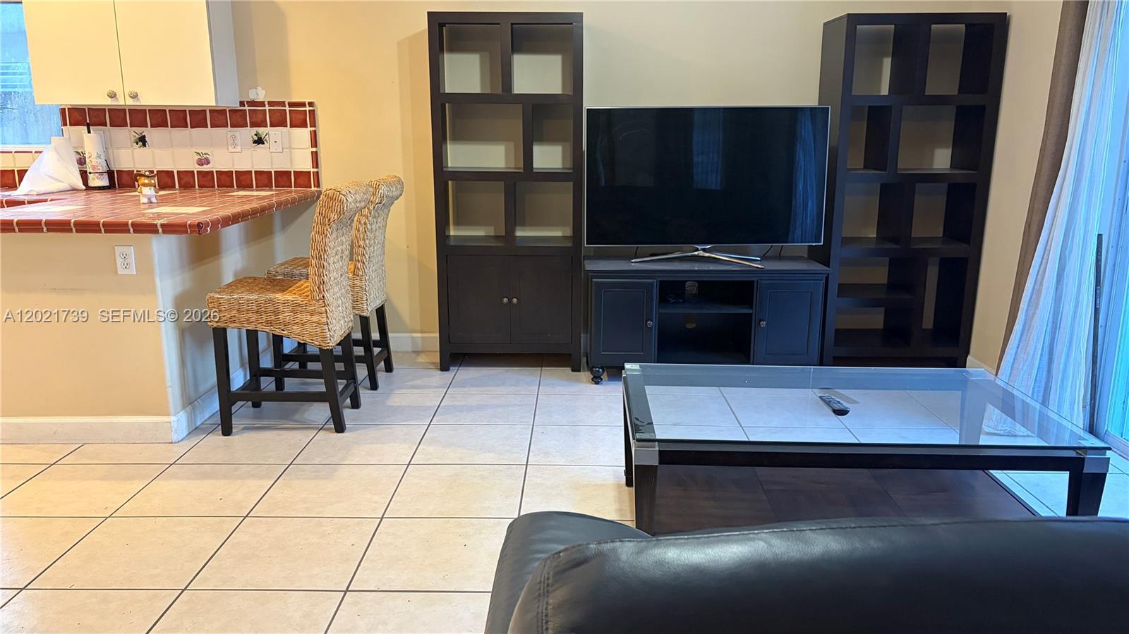 13553 Southwest 124th Avenue Road Miami, FL 33186 - Photo 9 of 31 a room with furniture and a flat screen tv