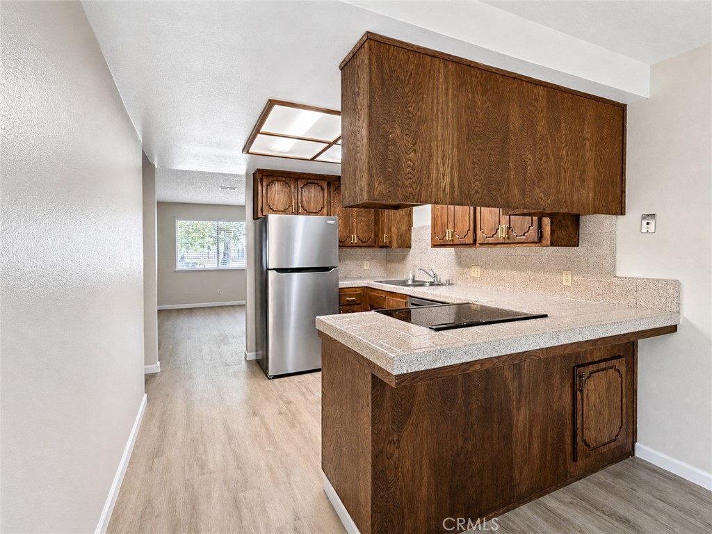 2180 Bellevue Road Atwater, CA 95301 - Photo 15 of 31 a kitchen with a sink a refrigerator and cabinets