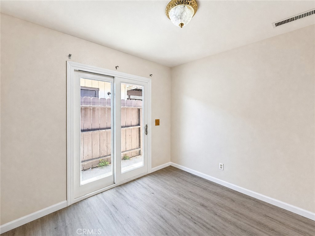 2180 Bellevue Road Atwater, CA 95301 - Photo 19 of 31 an empty room with wooden floor and windows