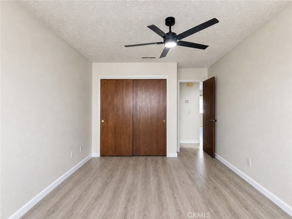 2180 Bellevue Road Atwater, CA 95301 - Photo 22 of 31 a view of a livingroom with a ceiling fan & wooden floor