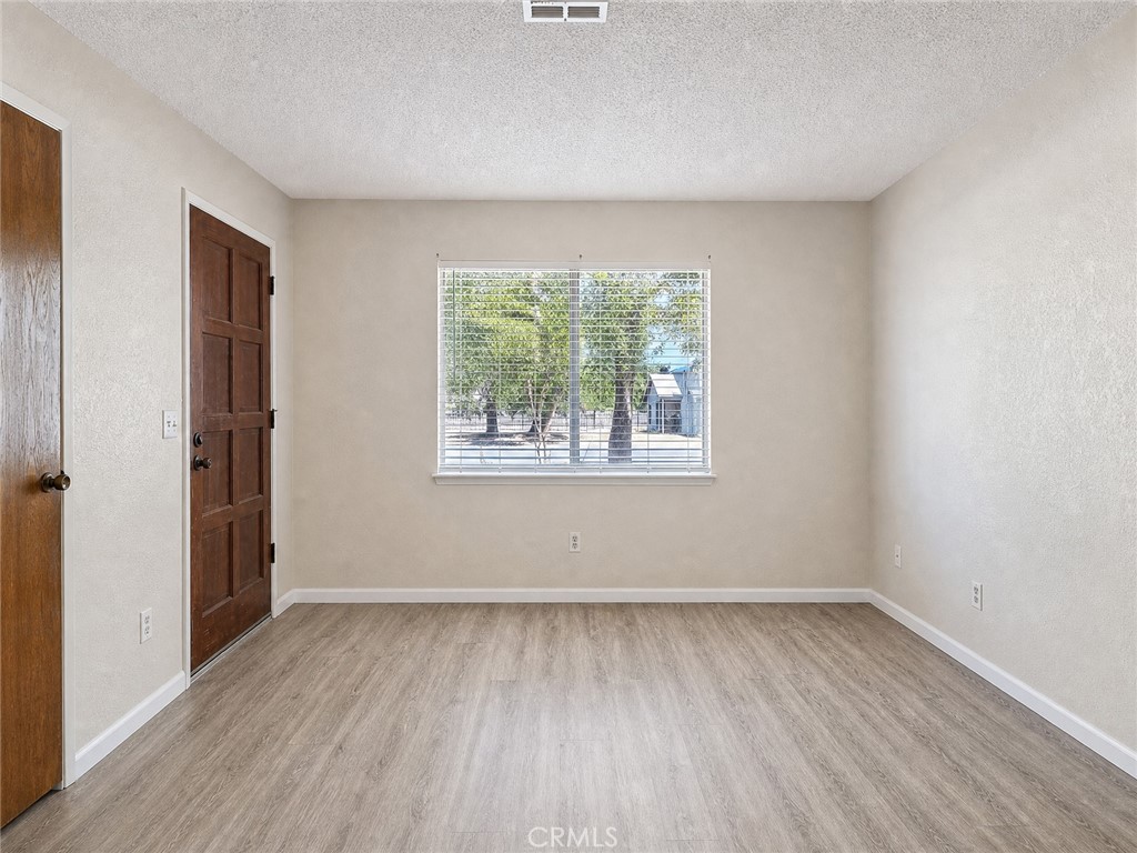 2180 Bellevue Road Atwater, CA 95301 - Photo 5 of 31 an empty room with wooden floor and windows
