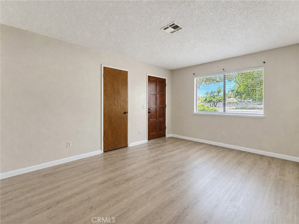 2180 Bellevue Road Atwater, CA 95301 - Photo 7 of 31 a view of an empty room with wooden floor and a window