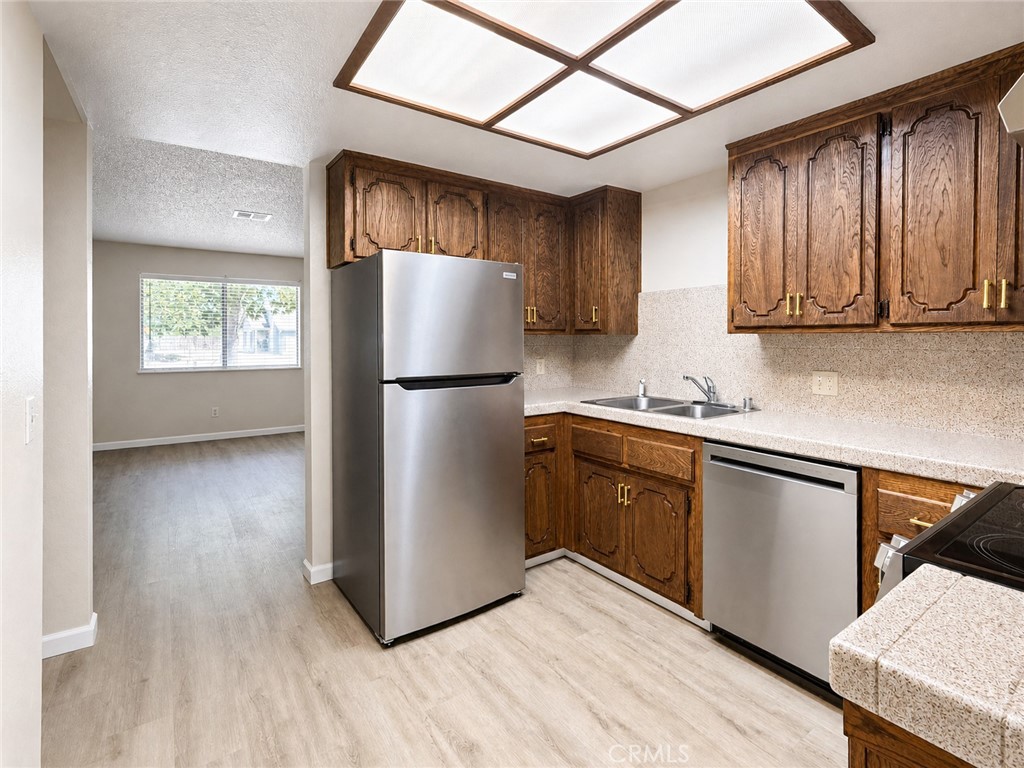 2180 Bellevue Road Atwater, CA 95301 - Photo 10 of 31 a kitchen with wooden cabinets and refrigerator
