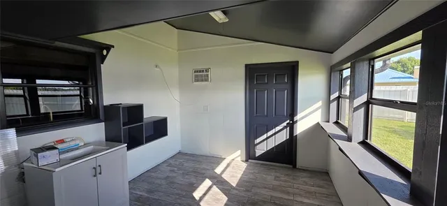 a view of a house with a big yard and large trees