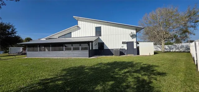 a view of a garden with lawn chairs and a fire pit