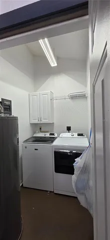 a bedroom with a bed and a television