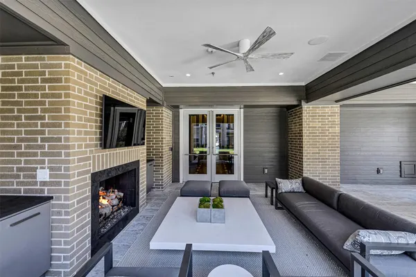 a living room with furniture flat screen tv and a fireplace