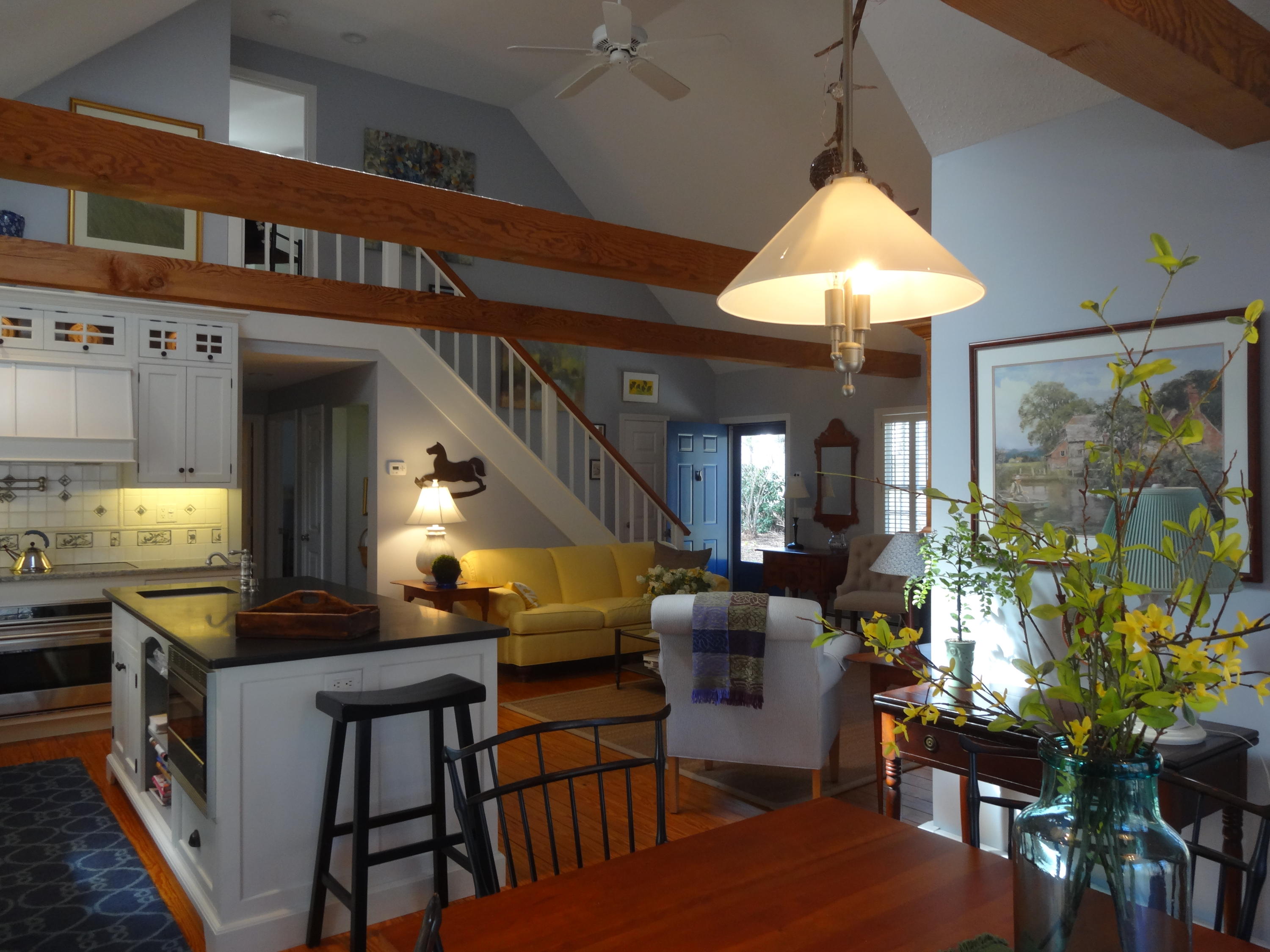 105 Cole Road Eastham, MA 02642 - Photo 7 of 30 a open kitchen with stainless steel appliances granite countertop a stove a refrigerator a dining table and chairs with the outer view