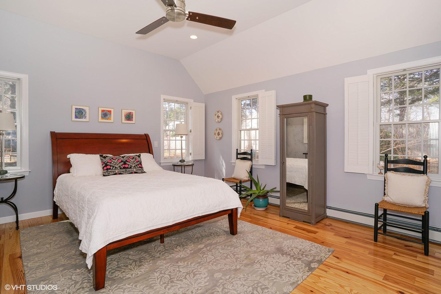 105 Cole Road Eastham, MA 02642 - Photo 9 of 30 a bedroom with a bed and wooden floor