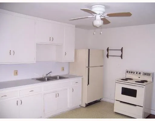 a kitchen with cabinets stainless steel appliances and a counter space
