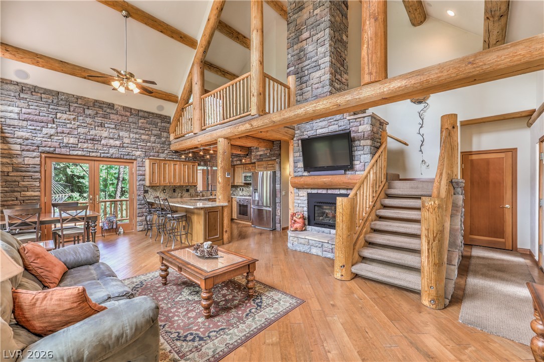 322 Ski Trail Road Mount Charleston, NV 89124 - Photo 14 of 58 Soaring beamed ceilings and a massive stone fireplace anchor this open log cabin interior.