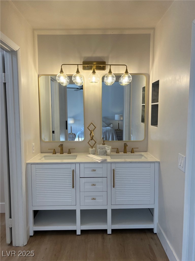 2712 Rialto Road Las Vegas, NV 89108 - Photo 39 of 54 Ensuite bathroom featuring double vanity and wood finished floors