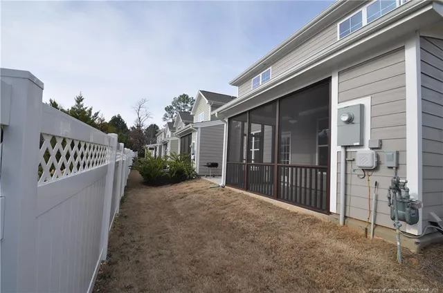 a view of a house with backyard and porch