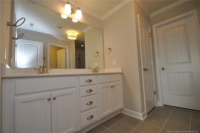 a bathroom with a double vanity sink mirror and