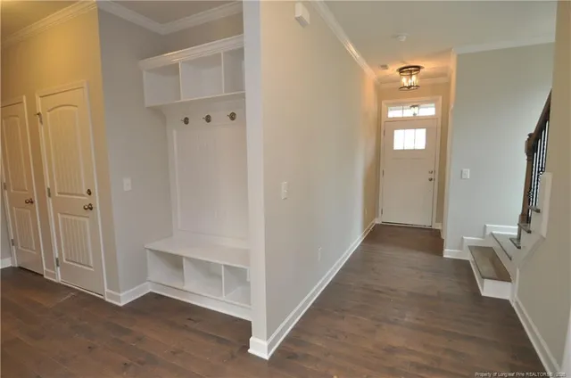 a view of a hallway with wooden floor and closet area