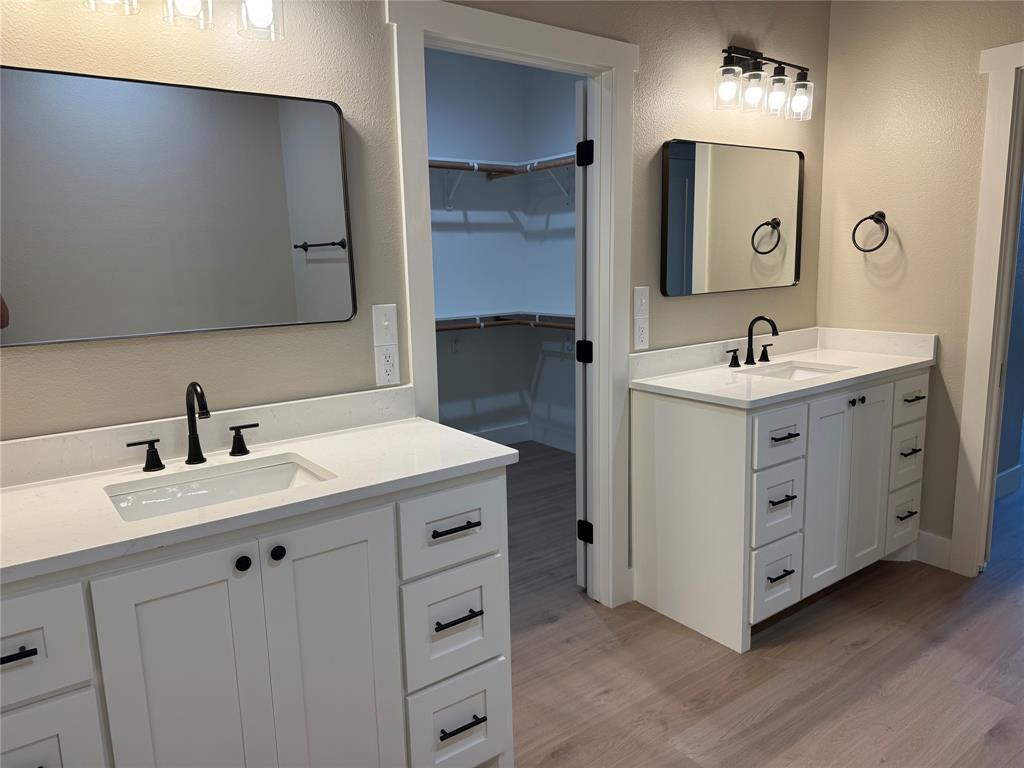 143 Ridge Road Tuscola, TX 79562 - Photo 11 of 24 a bathroom with a double vanity sink and mirror