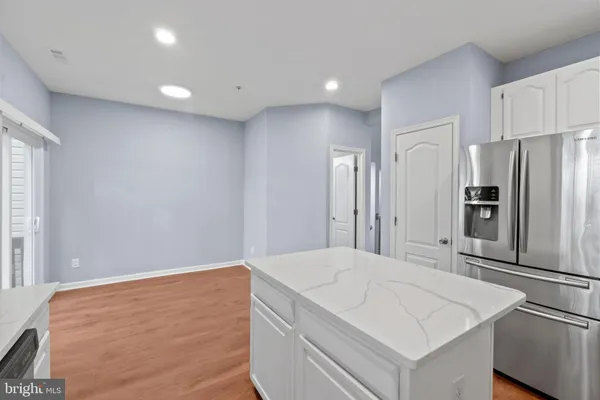a kitchen with stainless steel appliances a refrigerator and a stove