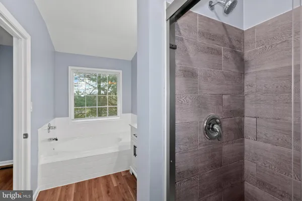 a bathroom with a bathtub and shower