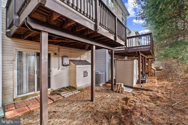 a view of a house with backyard and deck