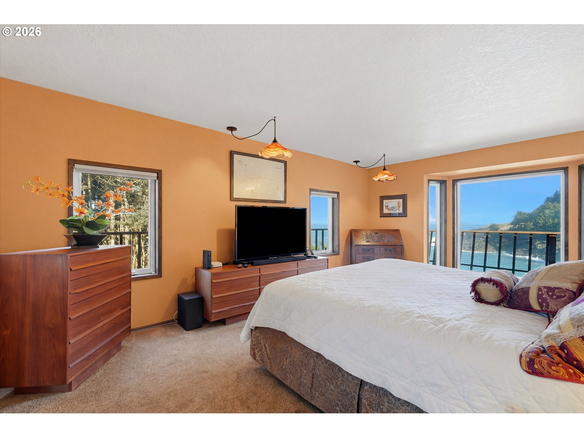 3355 Otter Crest Loop Depoe Bay, OR 97341 - Photo 11 of 35 a bedroom with furniture and a flat screen tv