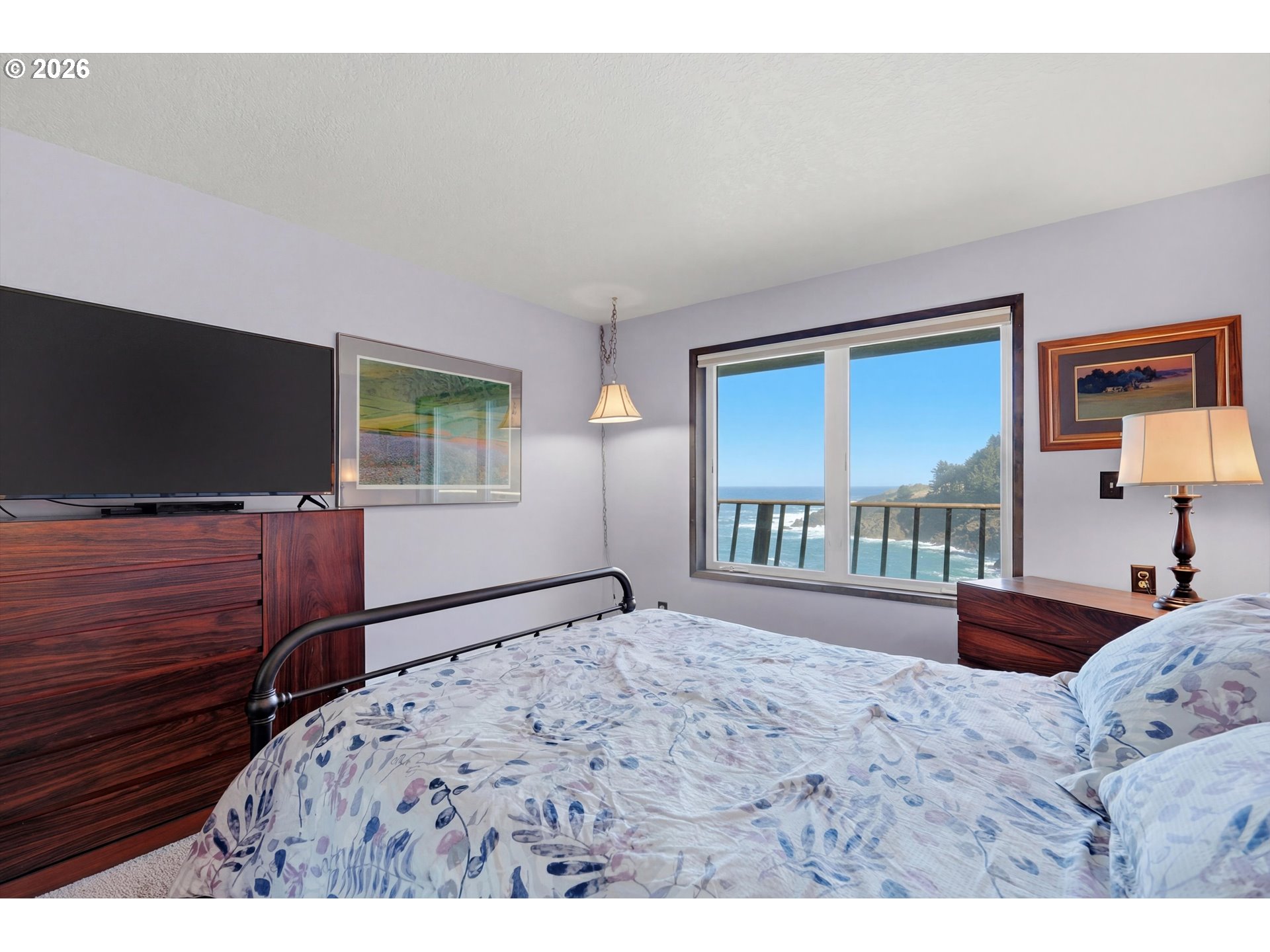 3355 Otter Crest Loop Depoe Bay, OR 97341 - Photo 13 of 35 a bedroom with a bed and a flat screen tv