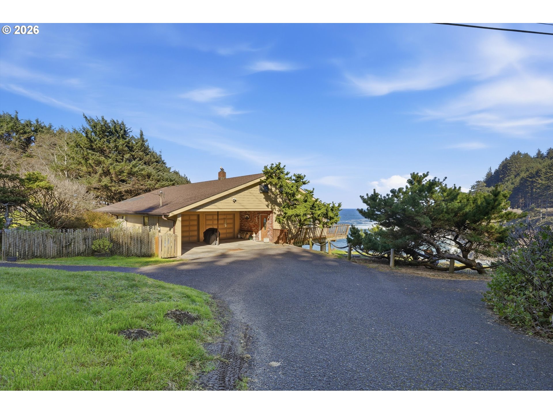 3355 Otter Crest Loop Depoe Bay, OR 97341 - Photo 24 of 35 a front view of a house with a yard and garage