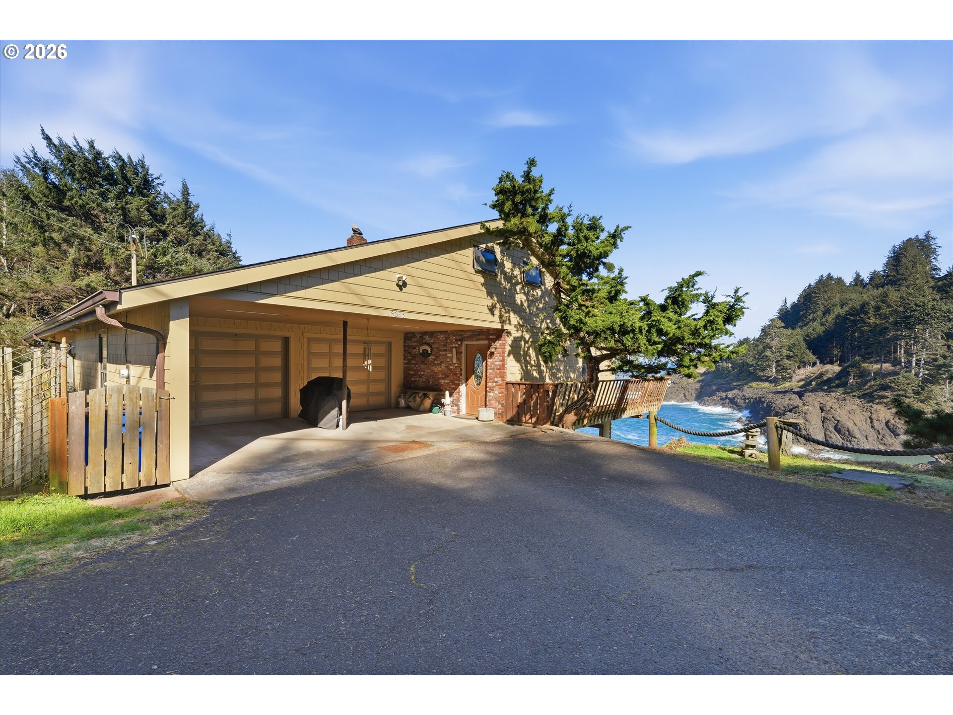 3355 Otter Crest Loop Depoe Bay, OR 97341 - Photo 29 of 35 a front view of a house with a yard and a garage