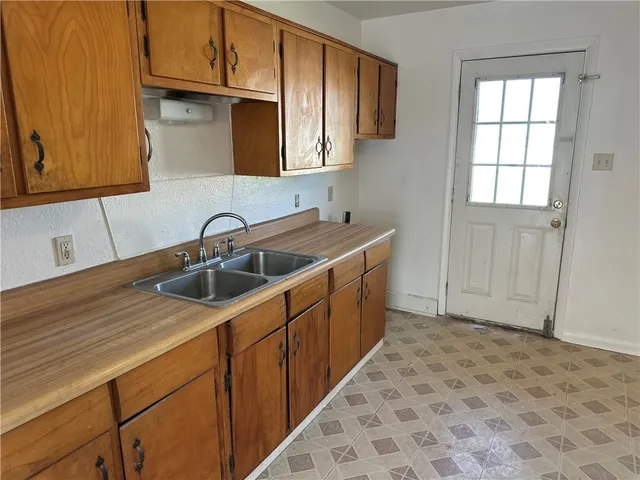 a kitchen with sink cabinets and utility