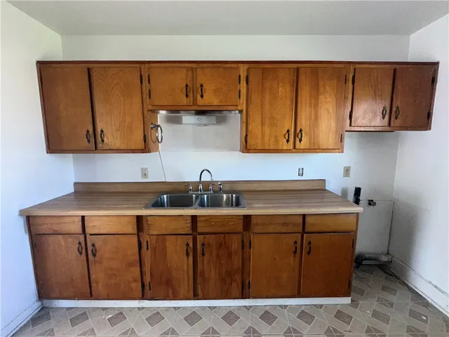 a utility room with wooden floor washer and dryer